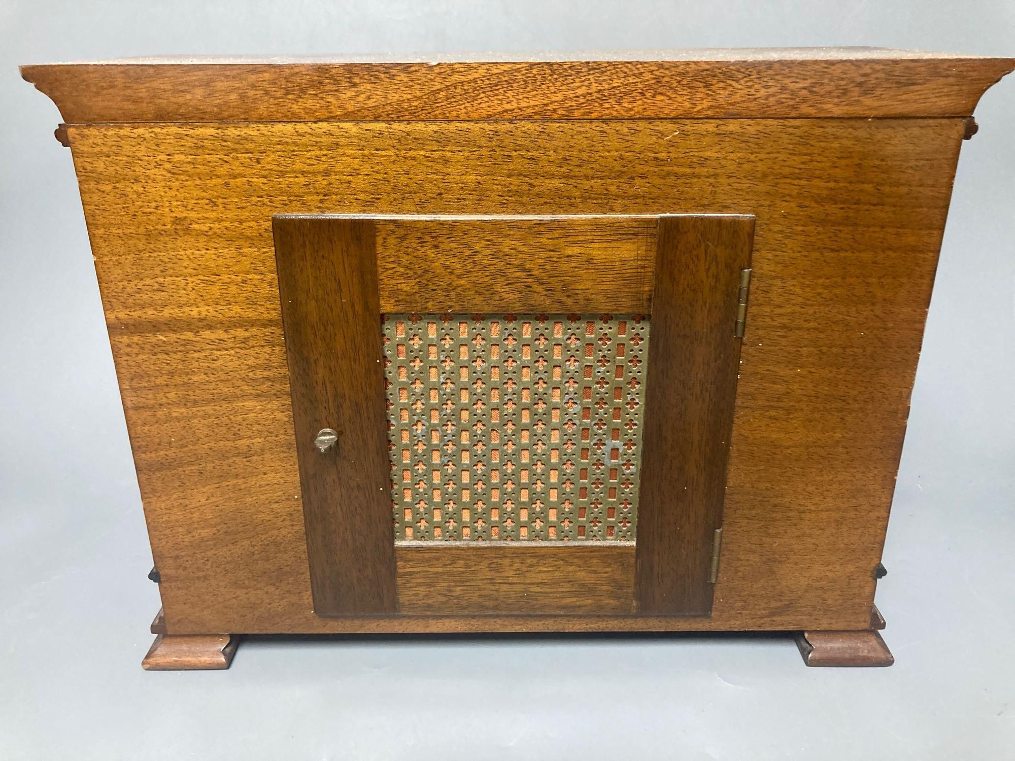 A mahogany mantel clock with ebonised decoration, by Elliott of London, width 33cm, height 25cm